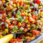 Looking for the best Cowboy Caviar recipe? This fresh and easy black bean salsa is loaded with avocado, corn, tomatoes, and the best dressing. Perfect for cookouts, parties, and summer gatherings!