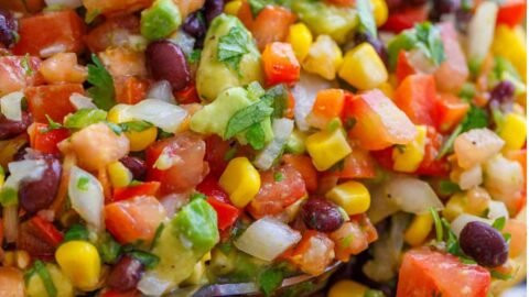 Looking for the best Cowboy Caviar recipe? This fresh and easy black bean salsa is loaded with avocado, corn, tomatoes, and the best dressing. Perfect for cookouts, parties, and summer gatherings!