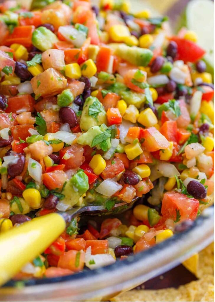 Looking for the best Cowboy Caviar recipe? This fresh and easy black bean salsa is loaded with avocado, corn, tomatoes, and the best dressing. Perfect for cookouts, parties, and summer gatherings!