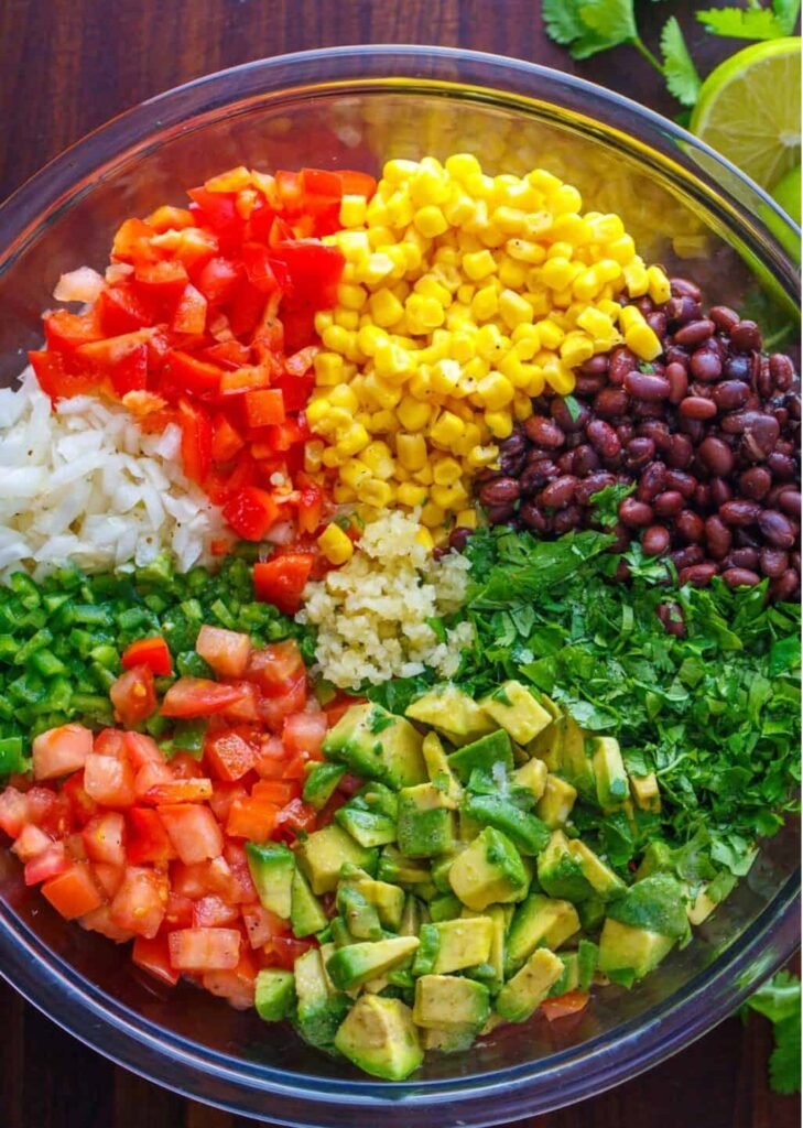Looking for the best Cowboy Caviar recipe? This fresh and easy black bean salsa is loaded with avocado, corn, tomatoes, and the best dressing. Perfect for cookouts, parties, and summer gatherings!