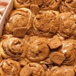 There’s something magical about pulling a pan of warm cinnamon rolls from the oven, especially when those rolls are packed with Biscoff cookie butter. These Biscoff Cookie Butter Cinnamon Rolls take the classic homemade cinnamon roll and give it a delicious cookie-butter twist. The dough is soft and fluffy, the center is filled with buttery brown sugar, cinnamon, and rich Biscoff spread, and the finished rolls can be topped with a creamy Biscoff frosting or an extra drizzle of warmed cookie butter. The result? Soft, gooey cinnamon rolls with warm cinnamon spice and that unmistakable caramelized Biscoff flavor in every bite. They’re perfect for a lazy weekend breakfast, holiday brunch, afternoon coffee, or whenever you're craving something sweet and comforting. Biscoff is especially well suited to cinnamon rolls because its caramelized, lightly spiced flavor complements the cinnamon filling beautifully. Why You'll Love Biscoff Cookie Butter Cinnamon Rolls Soft and fluffy texture: The homemade yeast dough bakes into wonderfully tender rolls with a pillowy center. Every bite has that bakery-style softness you want from a great cinnamon roll. Rich Biscoff flavor: Cookie butter melts into the cinnamon filling, creating a deep caramelized and gently spiced flavor. It turns an ordinary cinnamon roll into something extra special. Gooey cinnamon filling: Brown sugar, butter, cinnamon, and Biscoff create a luscious filling that settles beautifully between the layers. The center is the best part! Perfect for breakfast or brunch: These rolls make a cozy weekend breakfast but are also impressive enough for holidays and special occasions. Serve them warm with coffee, tea, or a cold glass of milk. A Biscoff lover's dream: From the filling to the optional frosting and cookie crumbs, there are plenty of ways to add more Biscoff flavor. One bite and you'll understand the obsession. What Makes Homemade Better? Store-bought cinnamon rolls are convenient, but homemade rolls have a completely different texture and flavor. When you make these Biscoff cinnamon rolls from scratch, you can control the dough, filling, sweetness, and amount of cookie butter. The dough is allowed to rise until soft and puffy, giving the finished rolls a tender texture that pairs beautifully with the rich filling. Homemade also means you can serve them warm from the oven, when the Biscoff filling is soft and gooey and the aroma of cinnamon fills the kitchen. And perhaps the biggest advantage is customization. Want extra cookie butter? Add it. Love crushed Biscoff cookies? Sprinkle them over the top. Prefer cream cheese frosting? Make it extra thick. Ingredients You’ll Need These irresistible Biscoff Cookie Butter Cinnamon Rolls feature a pillowy homemade dough wrapped around a decadent cinnamon-cookie butter filling, all finished with a silky glaze on top. The recipe involves a few steps, but every ingredient is straightforward to track down. This batch yields about 10 to 12 cinnamon rolls. For the Dough All-purpose flour — Creates the structure for the rolls while keeping the dough tender. Warm whole milk — Adds richness and moisture while helping create a soft, fluffy dough. Active dry or instant yeast — Gives the dough its lift and creates those light, airy layers. Granulated sugar — Adds sweetness to the dough and helps create a beautifully tender texture. Unsalted butter — Brings richness and softness to the dough. Eggs — Add structure, richness, and tenderness. Salt — Balances the sweetness and brings out the flavors of the butter, cinnamon, and Biscoff. For the Biscoff Filling Biscoff cookie butter — The star ingredient, adding that signature caramelized cookie flavor throughout the swirls. Unsalted butter — Helps create a rich, spreadable filling that melts beautifully into the dough. Brown sugar — Adds deep molasses sweetness and helps create a gooey cinnamon-roll center. Ground cinnamon — Gives the filling its classic warm, aromatic cinnamon flavor. Crushed Biscoff cookies — Optional, but highly recommended if you want extra cookie flavor and a little texture. For the Topping Cream cheese — Creates a smooth, slightly tangy frosting that balances the sweetness of the cookie butter. Biscoff cookie butter — Adds another layer of caramelized cookie flavor to the frosting. Powdered sugar — Sweetens the frosting while keeping it smooth. Vanilla extract — Adds a subtle layer of warmth and rounds out the flavors. Milk or heavy cream — Helps adjust the frosting to the perfect drizzleable consistency. Extra Biscoff cookies — Crushed cookies make an easy and attractive finishing touch. The combination of cookie butter, cinnamon, brown sugar, and a creamy topping is a common approach in Biscoff cinnamon-roll recipes because the flavors complement the enriched dough particularly well. Step-By-Step Direction Step 1: Prepare the Yeast Warm the milk until it is comfortably warm rather than hot. Combine it with the yeast and a little sugar, then let it sit until the mixture becomes foamy. If you're using instant yeast, you can generally mix it directly into the dough ingredients, but allowing the yeast to foam is a useful way to check that active dry yeast is working. Step 2: Make the Dough Add the melted butter, eggs, sugar, flour, and salt. Mix until a soft dough forms. Knead the dough until it becomes smooth and elastic. It should feel soft and slightly tacky rather than dry and stiff. Avoid adding too much flour because that can make the finished cinnamon rolls heavy. Step 3: Let the Dough Rise Place the dough in a lightly greased bowl and cover it. Let it rise in a warm, draft-free place until it becomes noticeably puffy and roughly doubles in size. This first rise is important because it gives the yeast time to develop the dough's structure and airy texture. Similar Biscoff cinnamon-roll recipes use a first rise followed by a second proof after shaping. Step 4: Roll Out the Dough Transfer the risen dough to a lightly floured surface and gently roll it into a large rectangle. Try to keep the thickness fairly even so the finished rolls bake consistently. Step 5: Add the Biscoff Filling Spread softened butter over the dough, followed by a thin, even layer of Biscoff cookie butter. Sprinkle the brown sugar and cinnamon evenly over the top. For even more Biscoff flavor, add finely crushed Biscoff cookies. Don't make the filling excessively thick. A thin, even layer makes the dough easier to roll and helps keep the beautiful spiral intact. Step 6: Roll and Slice Starting from one long edge, carefully roll the dough into a snug log. Use a sharp knife or unflavored dental floss to cut the log into even pieces. Arrange the rolls in a greased baking dish with the swirls facing upward. Step 7: Give the Rolls a Second Rise Cover the shaped rolls and allow them to rise again until they look soft, puffy, and expanded. This second proof helps produce the light, fluffy texture associated with bakery-style cinnamon rolls. Step 8: Bake Until Golden Bake the rolls in a preheated oven until the tops are lightly golden and the center rolls are cooked through. Keep an eye on them toward the end of baking. You want the rolls baked through but still soft and tender rather than dry. Step 9: Make the Biscoff Frosting While the rolls cool slightly, beat softened cream cheese and butter until smooth. Add Biscoff cookie butter, powdered sugar, and vanilla, then mix until creamy. If the frosting is too thick, add a small amount of milk or cream until it reaches your preferred consistency. Step 10: Frost and Serve Spread the frosting generously over the warm cinnamon rolls. For the ultimate Biscoff finish, drizzle warmed cookie butter over the top and scatter crushed Biscoff cookies across the rolls. Serve while they're still warm and gooey. Serving Suggestions With morning coffee — The caramelized cookie flavor pairs beautifully with a hot cup of coffee. With a cold glass of milk — A classic combination that balances the richness of the rolls. For weekend brunch — Serve alongside fresh berries, scrambled eggs, or a savory breakfast casserole. For holiday breakfast — These make a cozy addition to Thanksgiving, Christmas, or other special-morning menus. As an afternoon dessert — Warm one slightly and enjoy it with tea or coffee. With extra Biscoff drizzle — Warm a little cookie butter until smooth and drizzle it over individual servings. With crushed cookies — Add extra Biscoff crumbs immediately before serving for texture and visual appeal. Tips for the Best Results Don't over-flour the dough: A slightly tacky dough usually produces softer cinnamon rolls than a stiff, heavily floured dough. Add flour gradually and stop when the dough becomes manageable. Use warm, not hot, milk: Extremely hot milk can damage the yeast. The milk should feel warm rather than steaming hot when you add it. Warm the cookie butter slightly: Biscoff spread becomes easier to spread when gently warmed. A thin layer gives you better swirls and makes rolling the dough easier. Give the dough enough time to rise: Don't rely only on the clock; look for a dough that has become noticeably puffy and expanded. The dough's appearance matters more than an exact rising time. Don't overbake: Cinnamon rolls continue to firm up as they cool. Bake just until golden and cooked through so they stay soft and gooey in the center. Storage Tips Refrigerator Store leftover Biscoff cinnamon rolls in an airtight container in the refrigerator. They should stay soft for several days, although the texture is best when reheated. If possible, keep extra frosting separate and add it after reheating. Freezer For longer storage, freeze the baked rolls once they have cooled completely. Wrap individual rolls tightly and place them in a freezer-safe container or bag. You can also freeze the unbaked shaped rolls for a convenient make-ahead option, although the thawing and proofing process should be handled carefully. Reheating For the softest texture, warm individual rolls gently in the microwave until heated through. You can also reheat them in a low-temperature oven. Add a small drizzle of cookie butter or a little frosting afterward to bring back that fresh-from-the-oven richness. Make-ahead versions of Biscoff cinnamon rolls can also be assembled, refrigerated, and baked later; this is particularly useful for holiday breakfasts and brunches. Final Thoughts These Biscoff Cookie Butter Cinnamon Rolls are everything you want in a homemade sweet roll: soft, fluffy dough, a buttery cinnamon filling, rich cookie butter, and a creamy topping. The Biscoff flavor makes them feel a little more special than traditional cinnamon rolls without making the recipe complicated. They're the kind of treat that fills the kitchen with an irresistible aroma and makes everyone wonder when they can have the first one. For a cozy weekend breakfast, holiday brunch, or indulgent dessert, warm Biscoff cinnamon rolls are hard to resist. And if you're a serious Biscoff fan, don't stop with the frosting—add a warm cookie-butter drizzle and a sprinkle of crushed cookies right before serving. That's when these soft, gooey rolls really shine.