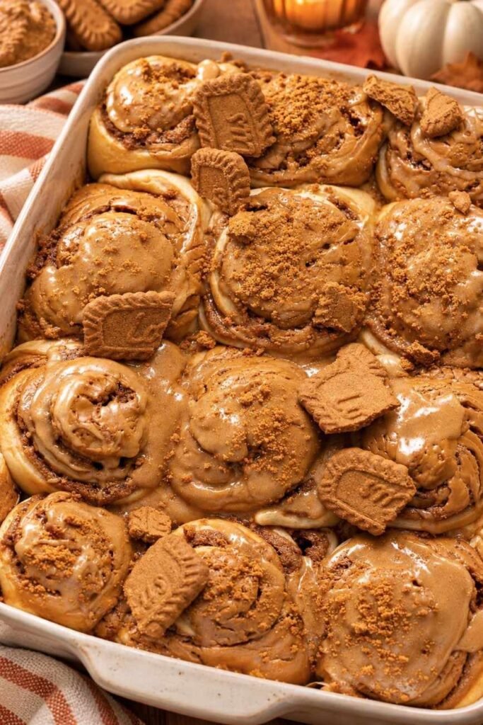 There’s something magical about pulling a pan of warm cinnamon rolls from the oven, especially when those rolls are packed with Biscoff cookie butter.
These Biscoff Cookie Butter Cinnamon Rolls take the classic homemade cinnamon roll and give it a delicious cookie-butter twist. The dough is soft and fluffy, the center is filled with buttery brown sugar, cinnamon, and rich Biscoff spread, and the finished rolls can be topped with a creamy Biscoff frosting or an extra drizzle of warmed cookie butter.
The result? Soft, gooey cinnamon rolls with warm cinnamon spice and that unmistakable caramelized Biscoff flavor in every bite.
They’re perfect for a lazy weekend breakfast, holiday brunch, afternoon coffee, or whenever you're craving something sweet and comforting. Biscoff is especially well suited to cinnamon rolls because its caramelized, lightly spiced flavor complements the cinnamon filling beautifully.
Why You'll Love Biscoff Cookie Butter Cinnamon Rolls
Soft and fluffy texture: The homemade yeast dough bakes into wonderfully tender rolls with a pillowy center.
 Every bite has that bakery-style softness you want from a great cinnamon roll.
Rich Biscoff flavor: Cookie butter melts into the cinnamon filling, creating a deep caramelized and gently spiced flavor.
 It turns an ordinary cinnamon roll into something extra special.
Gooey cinnamon filling: Brown sugar, butter, cinnamon, and Biscoff create a luscious filling that settles beautifully between the layers.
 The center is the best part!
Perfect for breakfast or brunch: These rolls make a cozy weekend breakfast but are also impressive enough for holidays and special occasions.
 Serve them warm with coffee, tea, or a cold glass of milk.
A Biscoff lover's dream: From the filling to the optional frosting and cookie crumbs, there are plenty of ways to add more Biscoff flavor.
 One bite and you'll understand the obsession.
What Makes Homemade Better?
Store-bought cinnamon rolls are convenient, but homemade rolls have a completely different texture and flavor.
When you make these Biscoff cinnamon rolls from scratch, you can control the dough, filling, sweetness, and amount of cookie butter. The dough is allowed to rise until soft and puffy, giving the finished rolls a tender texture that pairs beautifully with the rich filling.
Homemade also means you can serve them warm from the oven, when the Biscoff filling is soft and gooey and the aroma of cinnamon fills the kitchen.
And perhaps the biggest advantage is customization. Want extra cookie butter? Add it. Love crushed Biscoff cookies? Sprinkle them over the top. Prefer cream cheese frosting? Make it extra thick.
Ingredients You’ll Need
These irresistible Biscoff Cookie Butter Cinnamon Rolls feature a pillowy homemade dough wrapped around a decadent cinnamon-cookie butter filling, all finished with a silky glaze on top. The recipe involves a few steps, but every ingredient is straightforward to track down.
This batch yields about 10 to 12 cinnamon rolls.
For the Dough
All-purpose flour — Creates the structure for the rolls while keeping the dough tender.
Warm whole milk — Adds richness and moisture while helping create a soft, fluffy dough.
Active dry or instant yeast — Gives the dough its lift and creates those light, airy layers.
Granulated sugar — Adds sweetness to the dough and helps create a beautifully tender texture.
Unsalted butter — Brings richness and softness to the dough.
Eggs — Add structure, richness, and tenderness.
Salt — Balances the sweetness and brings out the flavors of the butter, cinnamon, and Biscoff.
For the Biscoff Filling
Biscoff cookie butter — The star ingredient, adding that signature caramelized cookie flavor throughout the swirls.
Unsalted butter — Helps create a rich, spreadable filling that melts beautifully into the dough.
Brown sugar — Adds deep molasses sweetness and helps create a gooey cinnamon-roll center.
Ground cinnamon — Gives the filling its classic warm, aromatic cinnamon flavor.
Crushed Biscoff cookies — Optional, but highly recommended if you want extra cookie flavor and a little texture.
For the Topping
Cream cheese — Creates a smooth, slightly tangy frosting that balances the sweetness of the cookie butter.
Biscoff cookie butter — Adds another layer of caramelized cookie flavor to the frosting.
Powdered sugar — Sweetens the frosting while keeping it smooth.
Vanilla extract — Adds a subtle layer of warmth and rounds out the flavors.
Milk or heavy cream — Helps adjust the frosting to the perfect drizzleable consistency.
Extra Biscoff cookies — Crushed cookies make an easy and attractive finishing touch.
The combination of cookie butter, cinnamon, brown sugar, and a creamy topping is a common approach in Biscoff cinnamon-roll recipes because the flavors complement the enriched dough particularly well.
Step-By-Step Direction
Step 1: Prepare the Yeast
Warm the milk until it is comfortably warm rather than hot. Combine it with the yeast and a little sugar, then let it sit until the mixture becomes foamy.
If you're using instant yeast, you can generally mix it directly into the dough ingredients, but allowing the yeast to foam is a useful way to check that active dry yeast is working.
Step 2: Make the Dough
Add the melted butter, eggs, sugar, flour, and salt. Mix until a soft dough forms.
Knead the dough until it becomes smooth and elastic. It should feel soft and slightly tacky rather than dry and stiff. Avoid adding too much flour because that can make the finished cinnamon rolls heavy.

Step 3: Let the Dough Rise
Place the dough in a lightly greased bowl and cover it. Let it rise in a warm, draft-free place until it becomes noticeably puffy and roughly doubles in size.
This first rise is important because it gives the yeast time to develop the dough's structure and airy texture. Similar Biscoff cinnamon-roll recipes use a first rise followed by a second proof after shaping.
Step 4: Roll Out the Dough
Transfer the risen dough to a lightly floured surface and gently roll it into a large rectangle.
Try to keep the thickness fairly even so the finished rolls bake consistently.

Step 5: Add the Biscoff Filling
Spread softened butter over the dough, followed by a thin, even layer of Biscoff cookie butter.
Sprinkle the brown sugar and cinnamon evenly over the top. For even more Biscoff flavor, add finely crushed Biscoff cookies.
Don't make the filling excessively thick. A thin, even layer makes the dough easier to roll and helps keep the beautiful spiral intact.

Step 6: Roll and Slice
Starting from one long edge, carefully roll the dough into a snug log.
Use a sharp knife or unflavored dental floss to cut the log into even pieces. Arrange the rolls in a greased baking dish with the swirls facing upward.

Step 7: Give the Rolls a Second Rise
Cover the shaped rolls and allow them to rise again until they look soft, puffy, and expanded.
This second proof helps produce the light, fluffy texture associated with bakery-style cinnamon rolls.
Step 8: Bake Until Golden
Bake the rolls in a preheated oven until the tops are lightly golden and the center rolls are cooked through.
Keep an eye on them toward the end of baking. You want the rolls baked through but still soft and tender rather than dry.
Step 9: Make the Biscoff Frosting
While the rolls cool slightly, beat softened cream cheese and butter until smooth. Add Biscoff cookie butter, powdered sugar, and vanilla, then mix until creamy.
If the frosting is too thick, add a small amount of milk or cream until it reaches your preferred consistency.
Step 10: Frost and Serve
Spread the frosting generously over the warm cinnamon rolls.
For the ultimate Biscoff finish, drizzle warmed cookie butter over the top and scatter crushed Biscoff cookies across the rolls.
Serve while they're still warm and gooey.

Serving Suggestions
With morning coffee — The caramelized cookie flavor pairs beautifully with a hot cup of coffee.
With a cold glass of milk — A classic combination that balances the richness of the rolls.
For weekend brunch — Serve alongside fresh berries, scrambled eggs, or a savory breakfast casserole.
For holiday breakfast — These make a cozy addition to Thanksgiving, Christmas, or other special-morning menus.
As an afternoon dessert — Warm one slightly and enjoy it with tea or coffee.
With extra Biscoff drizzle — Warm a little cookie butter until smooth and drizzle it over individual servings.
With crushed cookies — Add extra Biscoff crumbs immediately before serving for texture and visual appeal.
Tips for the Best Results
Don't over-flour the dough: A slightly tacky dough usually produces softer cinnamon rolls than a stiff, heavily floured dough.
 Add flour gradually and stop when the dough becomes manageable.
Use warm, not hot, milk: Extremely hot milk can damage the yeast.
 The milk should feel warm rather than steaming hot when you add it.
Warm the cookie butter slightly: Biscoff spread becomes easier to spread when gently warmed.
 A thin layer gives you better swirls and makes rolling the dough easier.
Give the dough enough time to rise: Don't rely only on the clock; look for a dough that has become noticeably puffy and expanded.
 The dough's appearance matters more than an exact rising time.
Don't overbake: Cinnamon rolls continue to firm up as they cool.
 Bake just until golden and cooked through so they stay soft and gooey in the center.
Storage Tips
Refrigerator
Store leftover Biscoff cinnamon rolls in an airtight container in the refrigerator. They should stay soft for several days, although the texture is best when reheated.
If possible, keep extra frosting separate and add it after reheating.
Freezer
For longer storage, freeze the baked rolls once they have cooled completely.
Wrap individual rolls tightly and place them in a freezer-safe container or bag. You can also freeze the unbaked shaped rolls for a convenient make-ahead option, although the thawing and proofing process should be handled carefully.
Reheating
For the softest texture, warm individual rolls gently in the microwave until heated through.
You can also reheat them in a low-temperature oven. Add a small drizzle of cookie butter or a little frosting afterward to bring back that fresh-from-the-oven richness.
Make-ahead versions of Biscoff cinnamon rolls can also be assembled, refrigerated, and baked later; this is particularly useful for holiday breakfasts and brunches.
Final Thoughts
These Biscoff Cookie Butter Cinnamon Rolls are everything you want in a homemade sweet roll: soft, fluffy dough, a buttery cinnamon filling, rich cookie butter, and a creamy topping.
The Biscoff flavor makes them feel a little more special than traditional cinnamon rolls without making the recipe complicated. They're the kind of treat that fills the kitchen with an irresistible aroma and makes everyone wonder when they can have the first one.
For a cozy weekend breakfast, holiday brunch, or indulgent dessert, warm Biscoff cinnamon rolls are hard to resist.
And if you're a serious Biscoff fan, don't stop with the frosting—add a warm cookie-butter drizzle and a sprinkle of crushed cookies right before serving. That's when these soft, gooey rolls really shine.